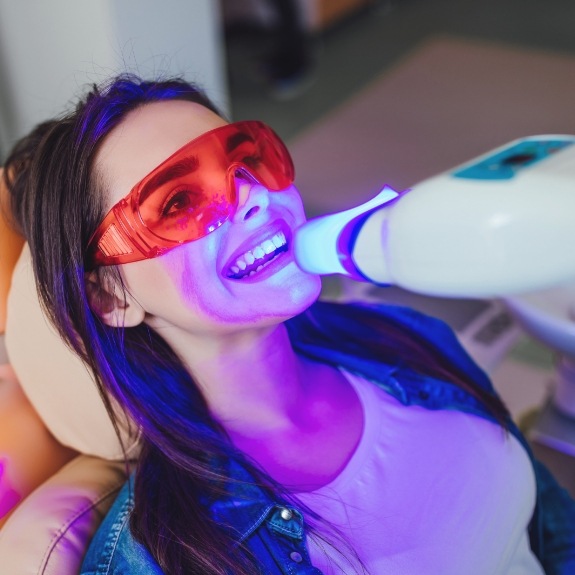 Woman getting professional teeth whitening