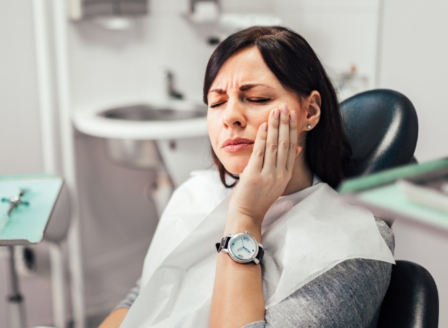 Woman holding her jaw in pain