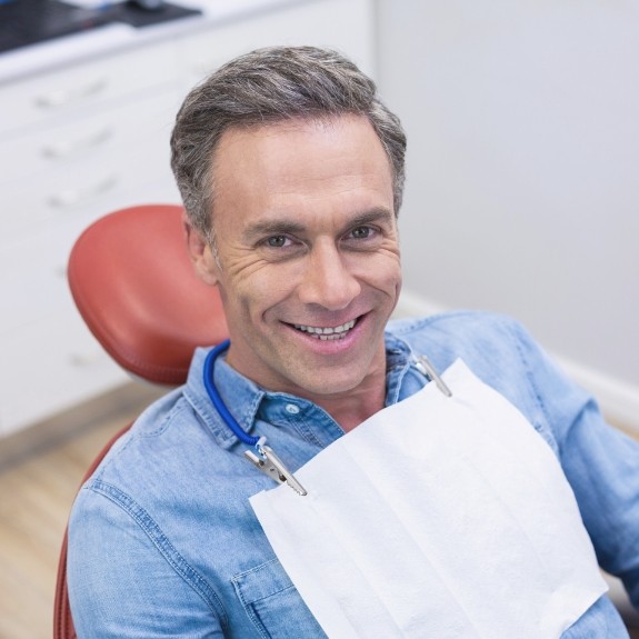 Smiling older man in dental chair