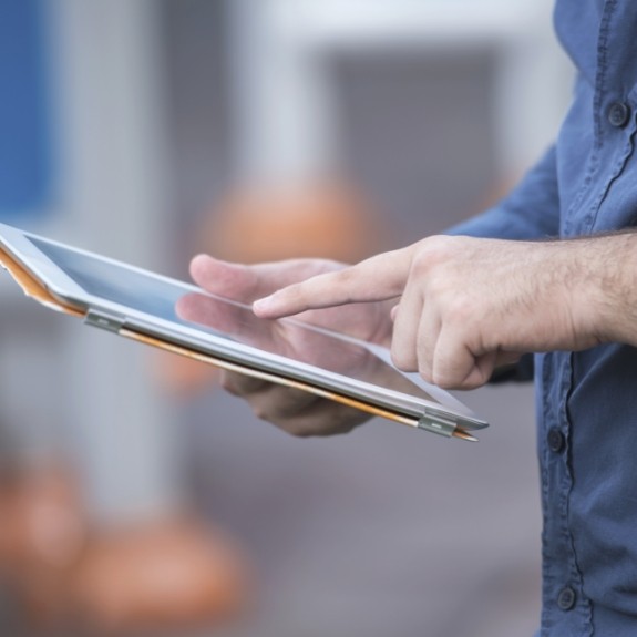 Person typing on tablet screen