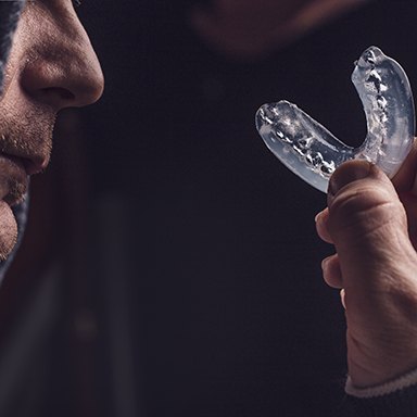 Person holding clear mouthguard