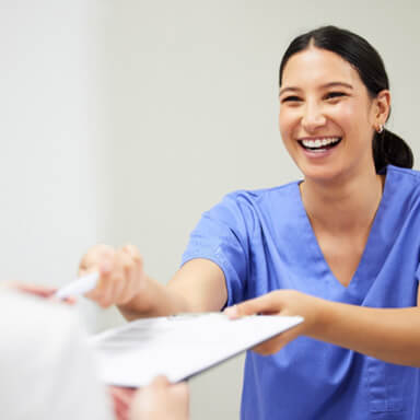 a patient signing a dental insurance form 