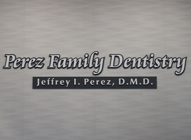 Perez Family Dentistry sign on wall of dental office