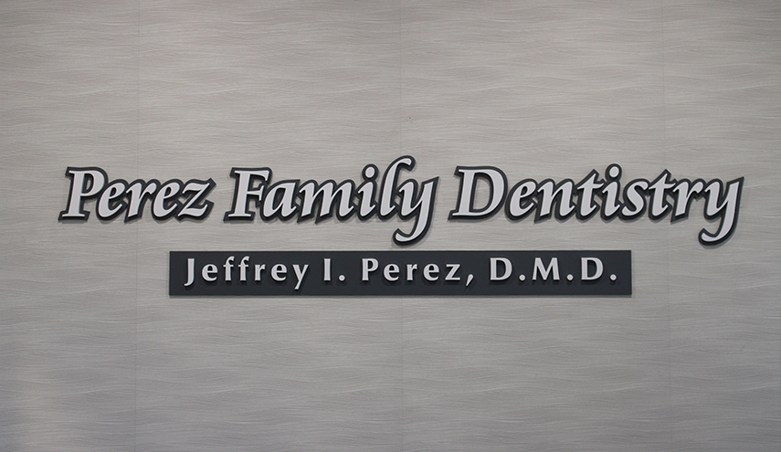 Perez Family Dentistry sign on wall of dental office