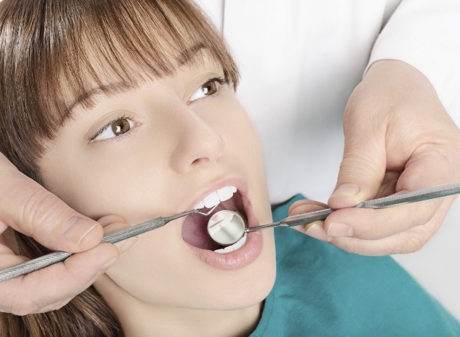 Woman getting dental exam