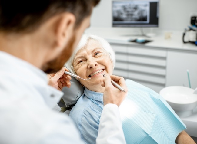 Senior woman smiling at her dentist