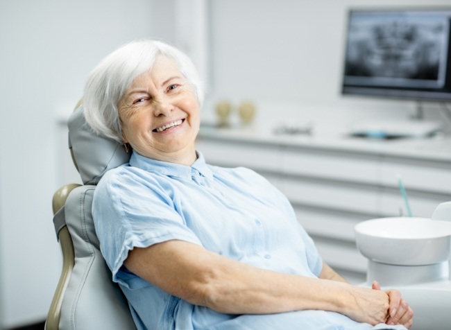 Senior woman in dental chair smiling